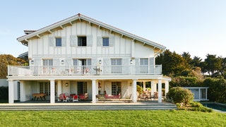 This typical halftimbered Basque baserri has been given a fresh contemporary look with woodwork painted in pale grey...