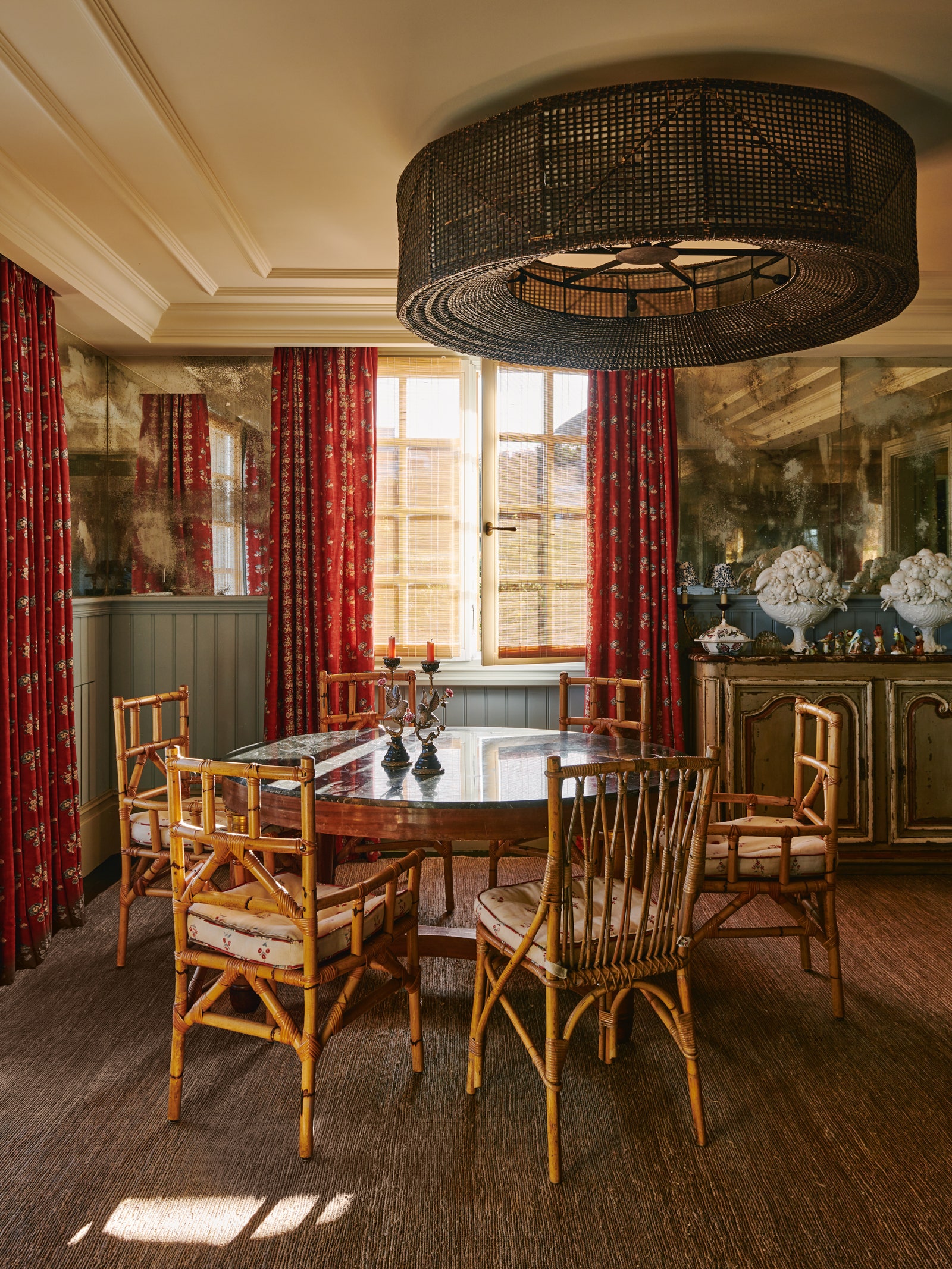 Verre glomis wall panels made by Arantxa Hergueta create an atmospheric backdrop for a large rattan ceiling light and...